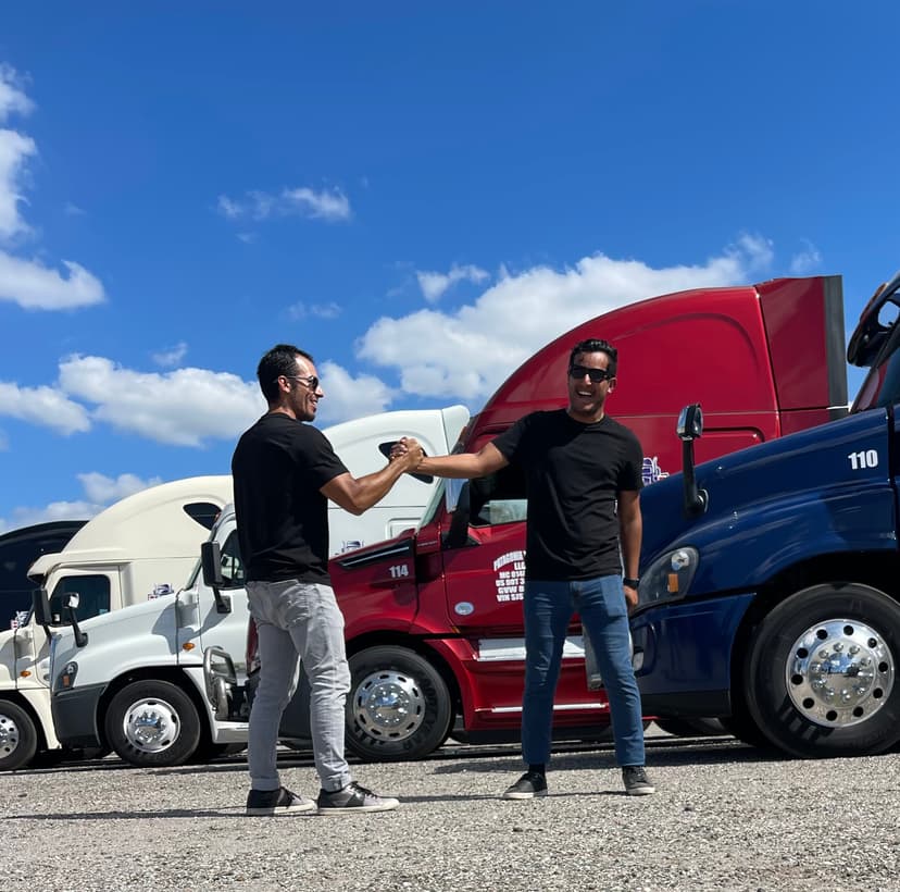 Yamil Morales CEO of MorPro shaking hands with trucking automation investor at fleet yard